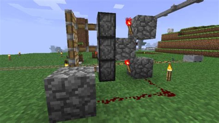 What property of redstone torches allows activating stacks of items?
